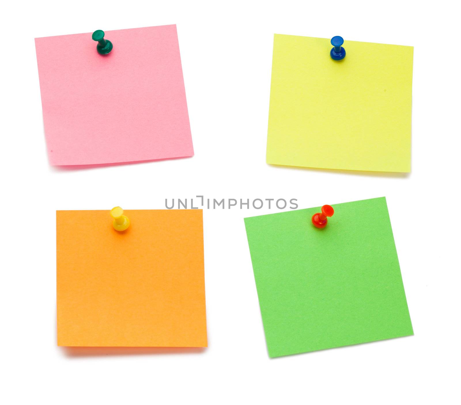Color post-its with drawing pins on a white background