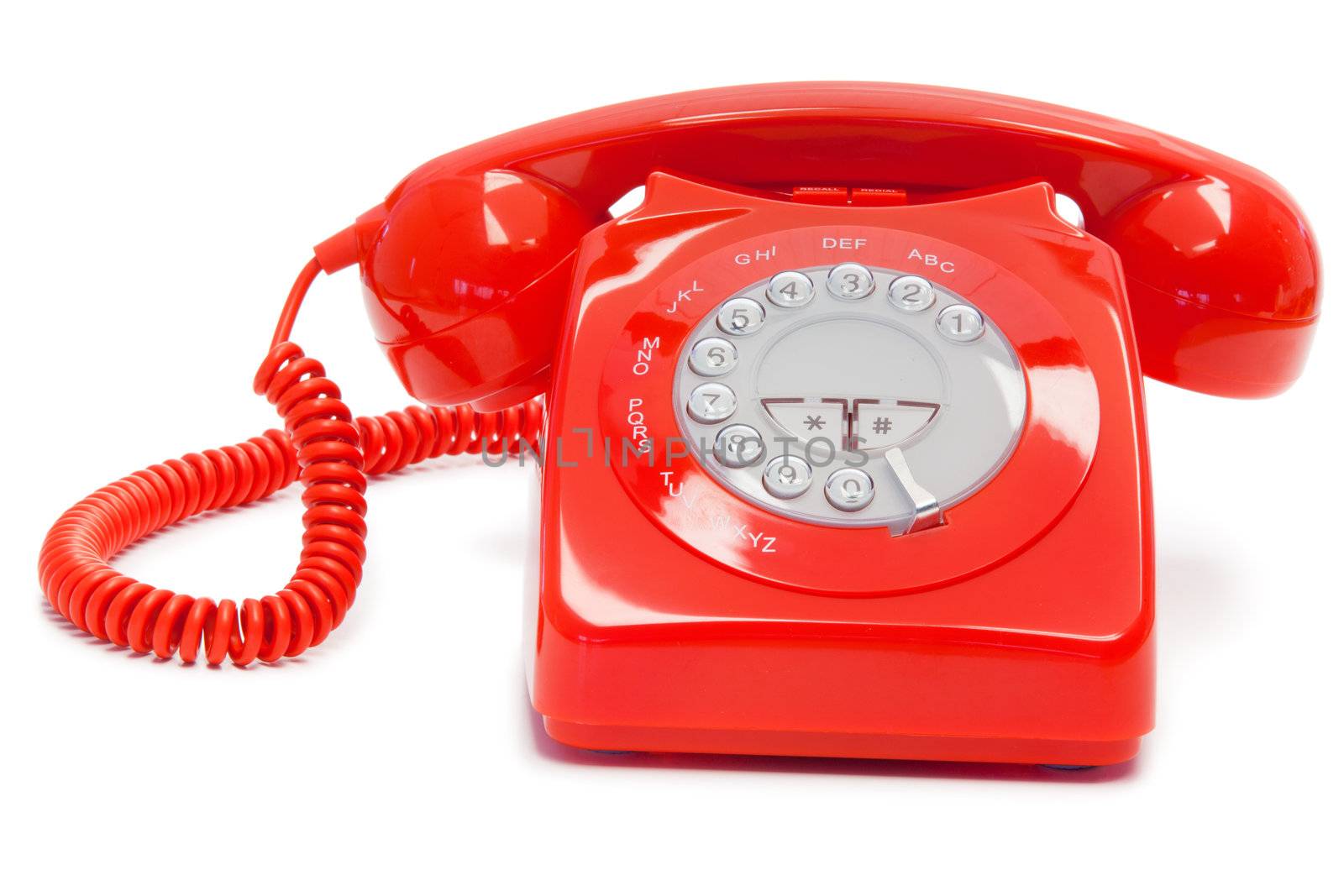Antique red telephone on a white background