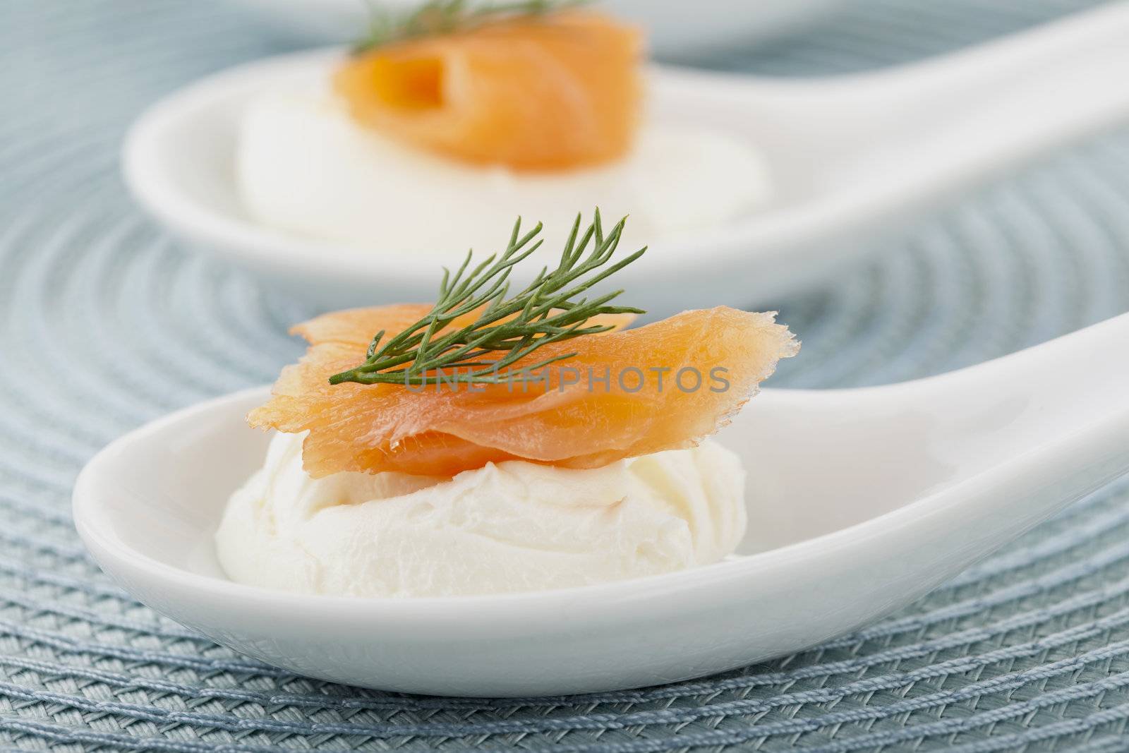 Close up image of smoked salmon with cream cheese  in spoon