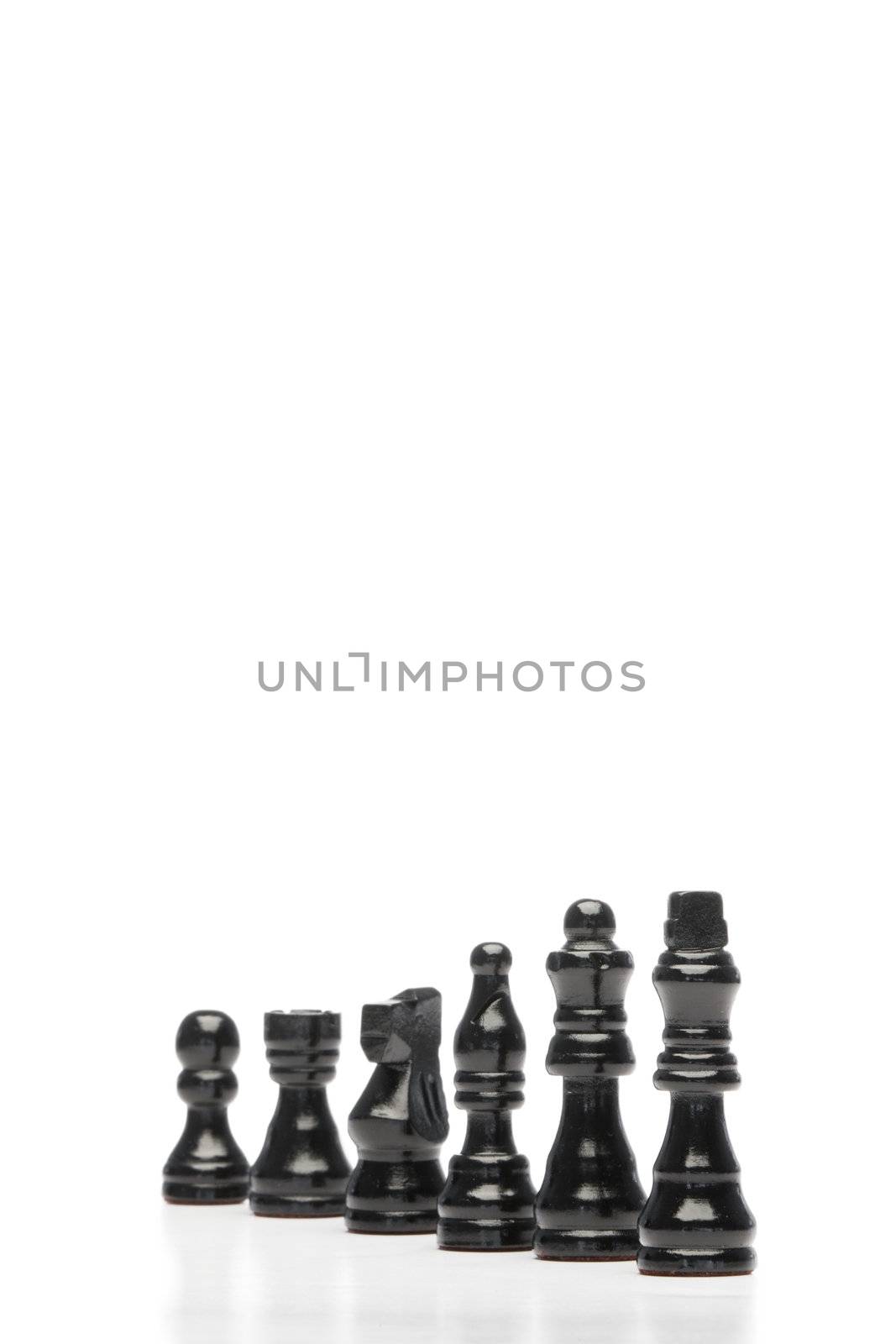 Dark pieces of chess on a white background