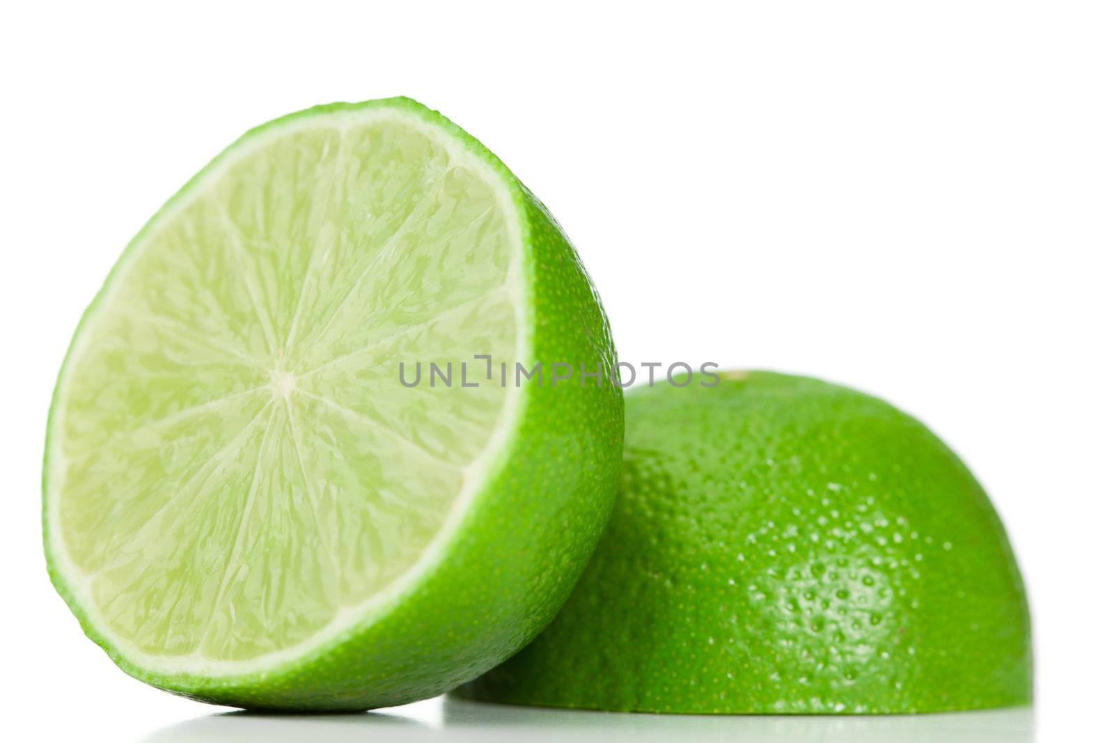 Green halved lemon on a white background