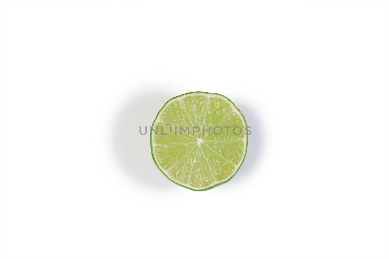 Half green lemon on a white background