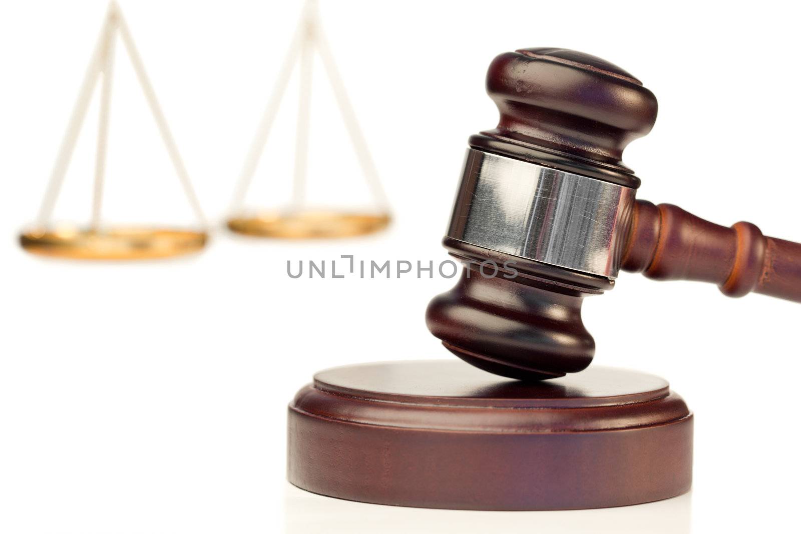 Brown gavel and scale of justice on a white background
