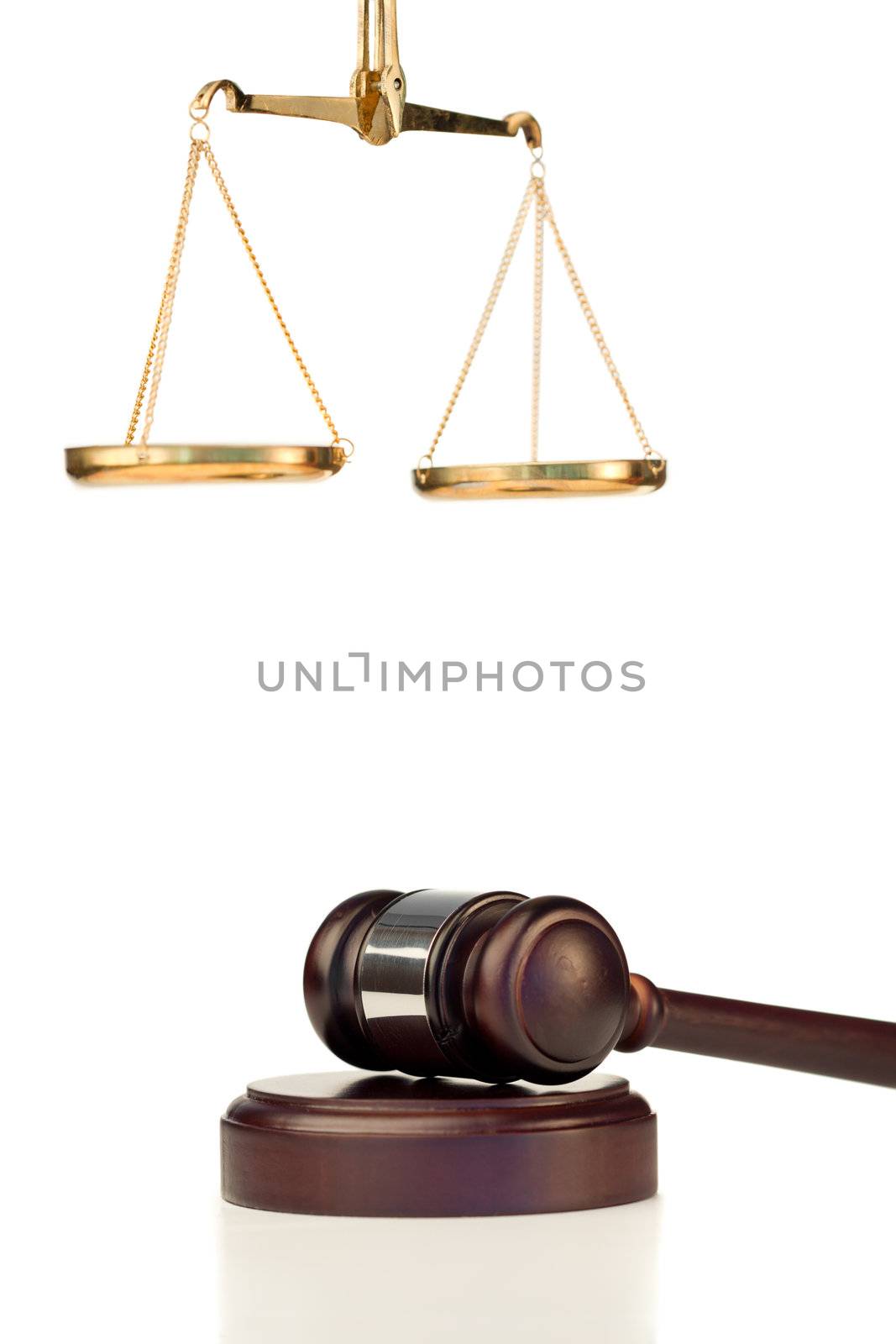 Fixed gavel and scale of justice on a white background