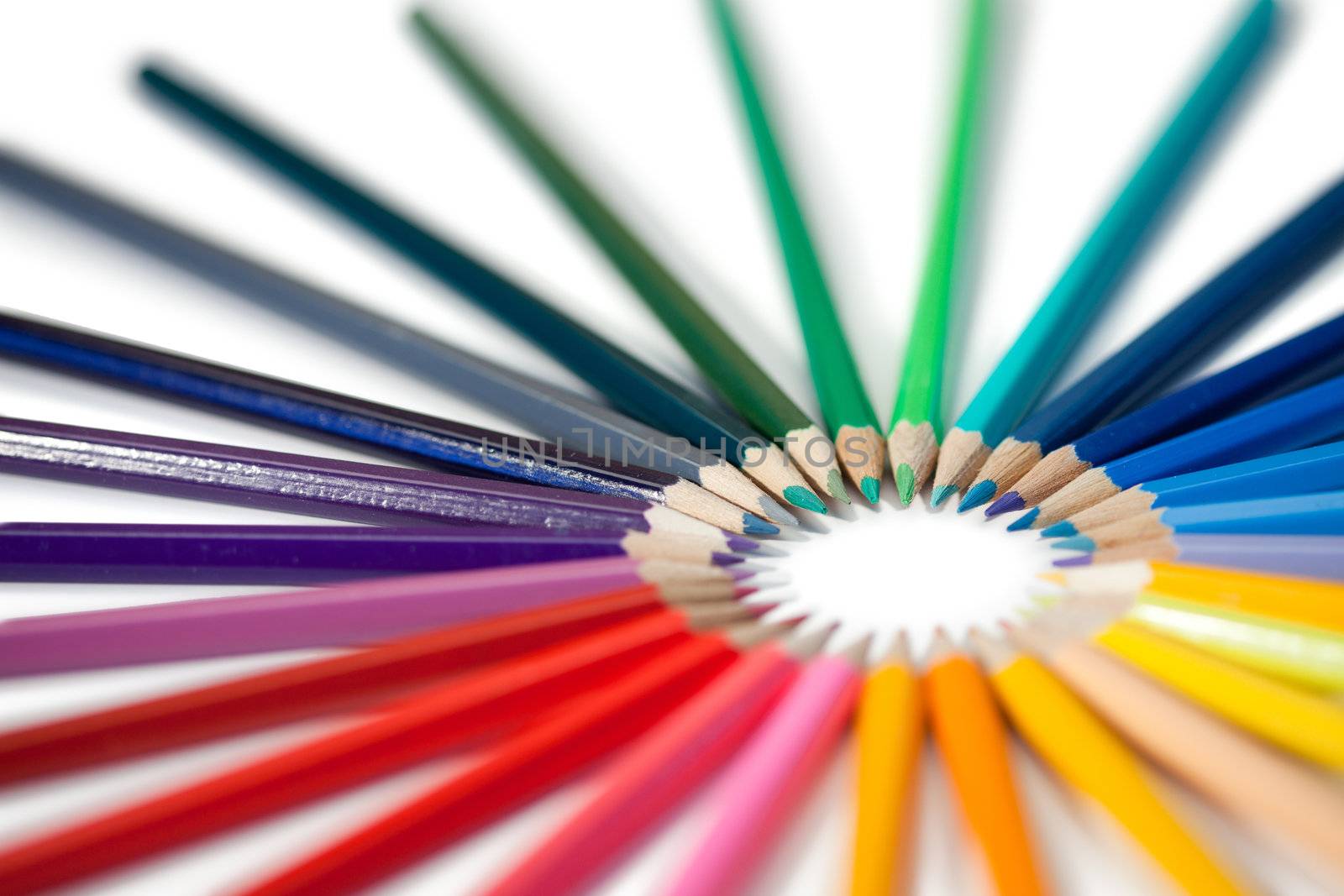 Angled color pencils star on a white background