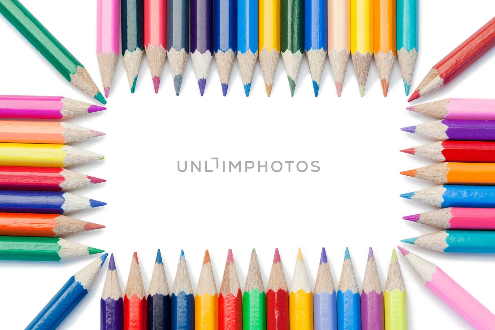 Color pencils forming a rectangle on a white background