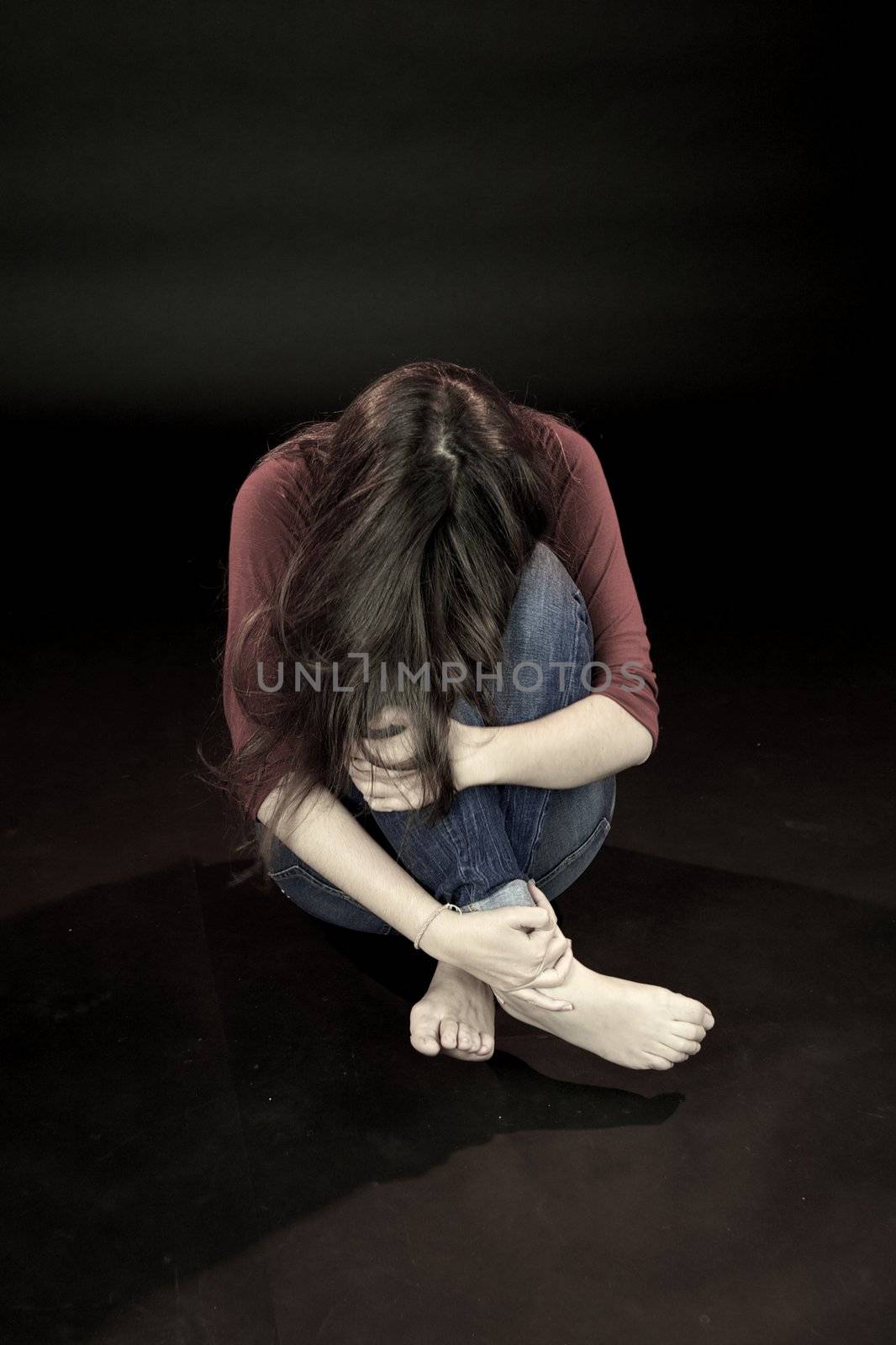 Young woman hiding scared about domestic violence by fmarsicano