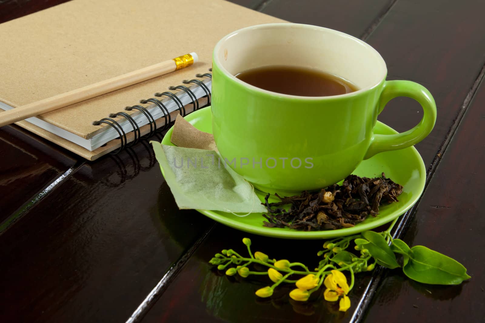 recycle notebook and wooden pencil on wood background