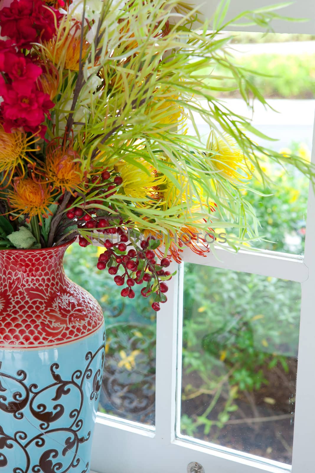 colorful vase and flower on the white table