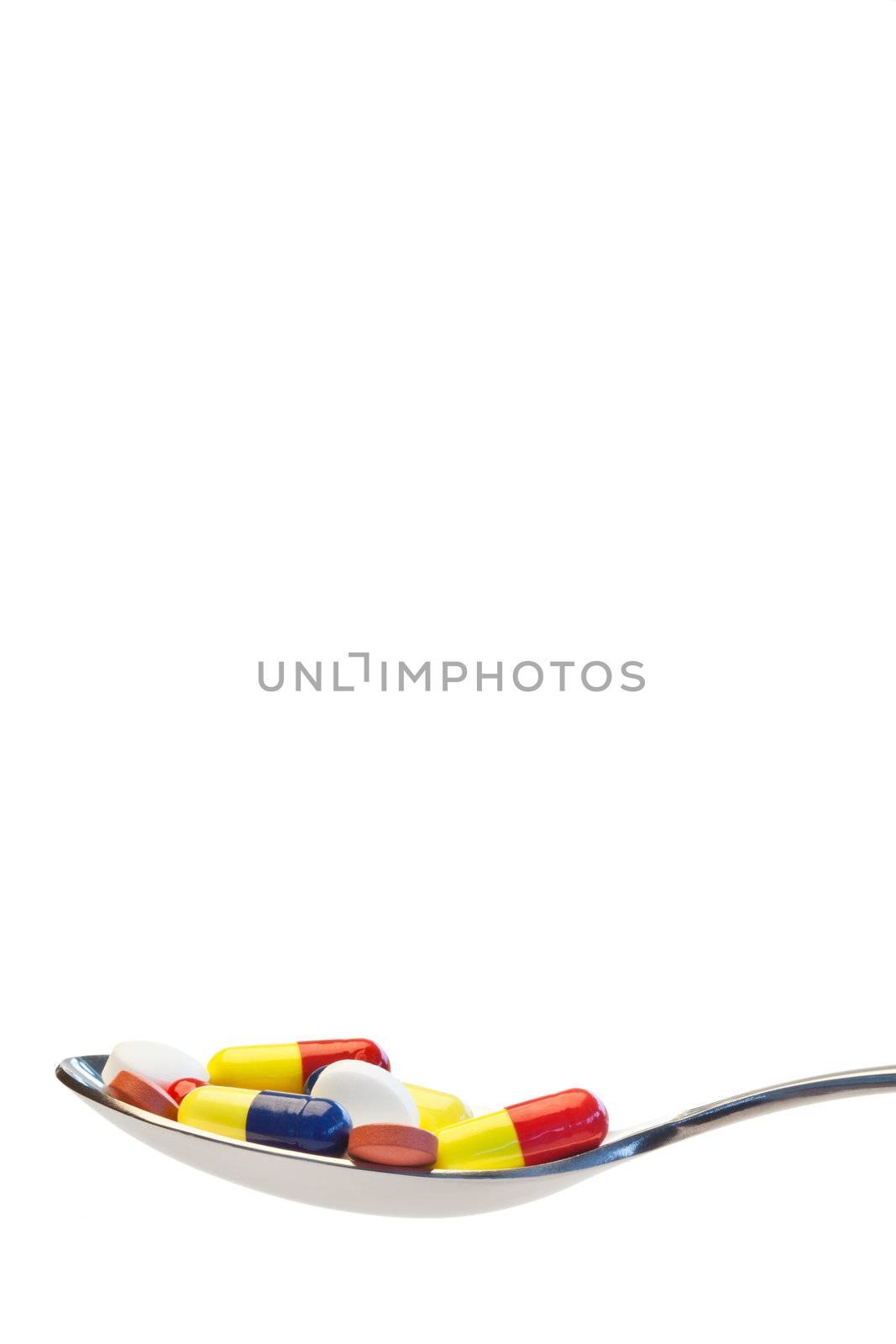 Spoon full of medicine on a white background