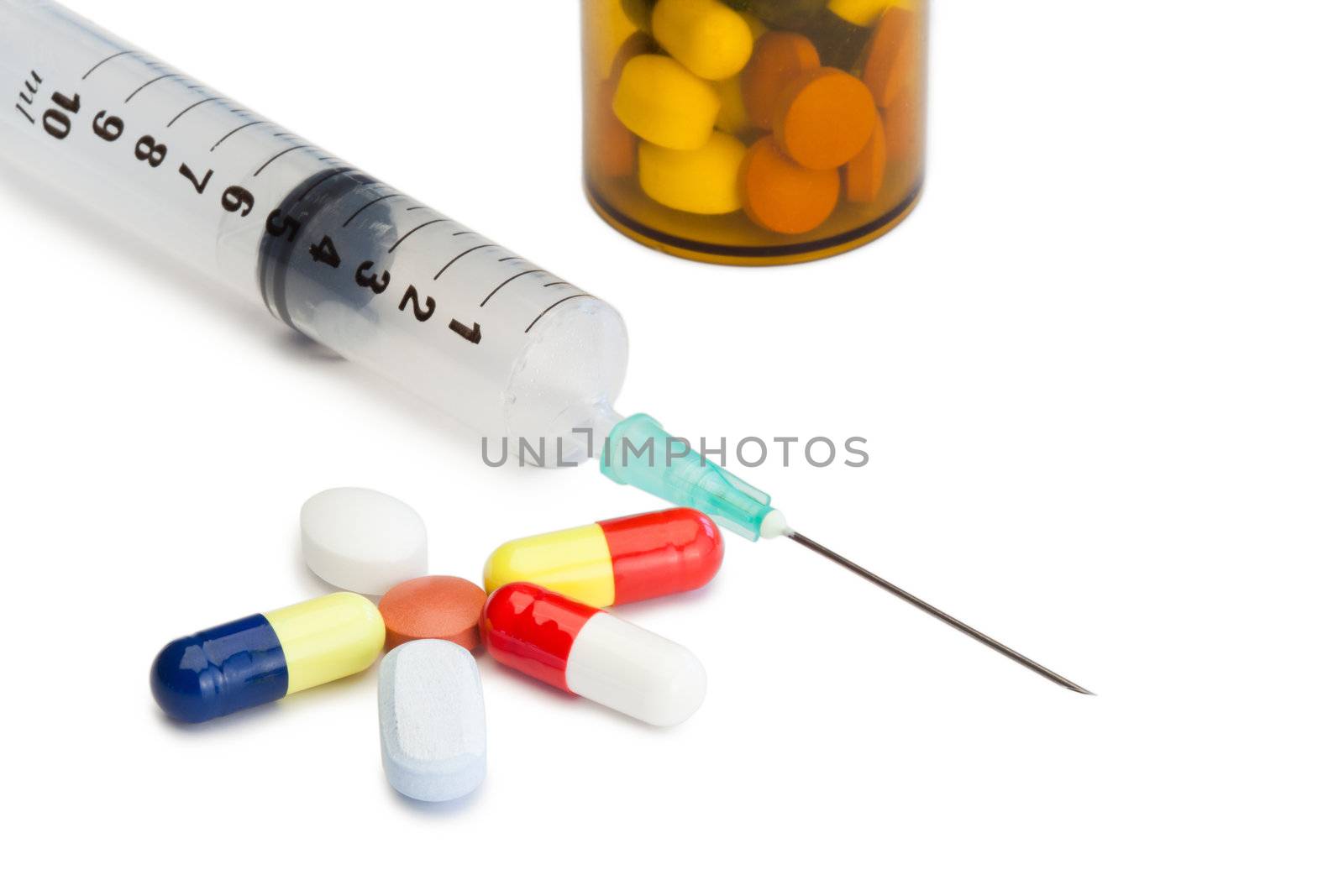 Pills with medicine box and serynge on a white background