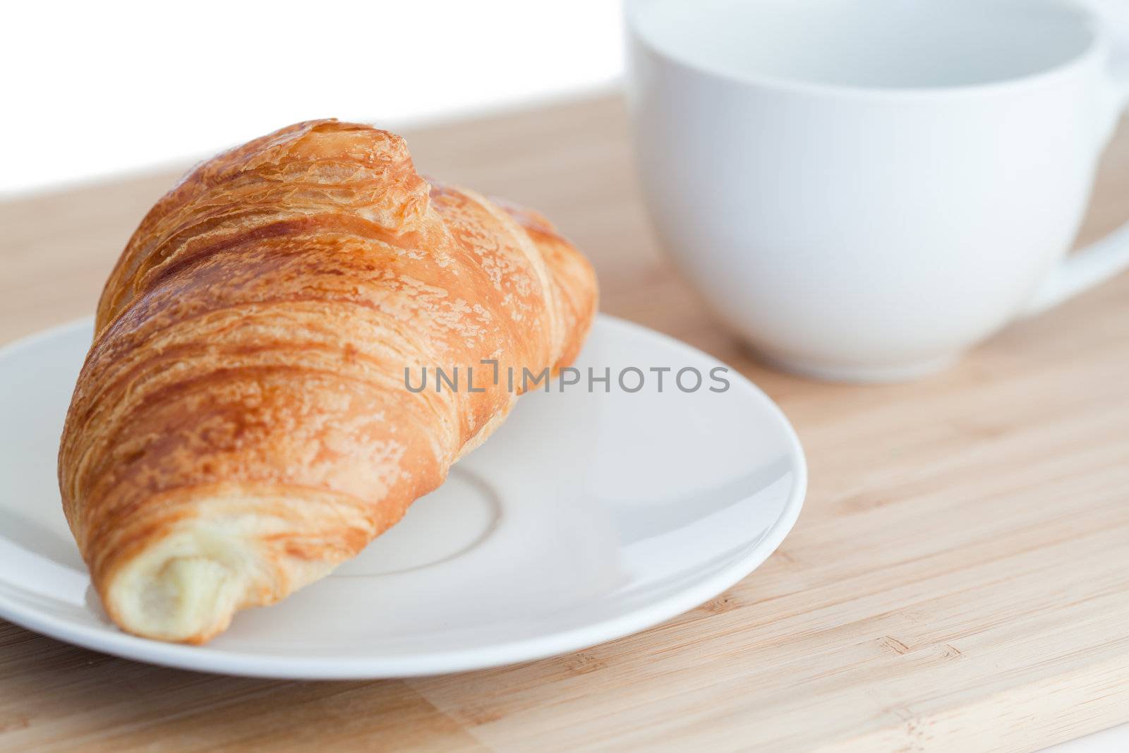 Breakfast with coffee and croissants on a white background
