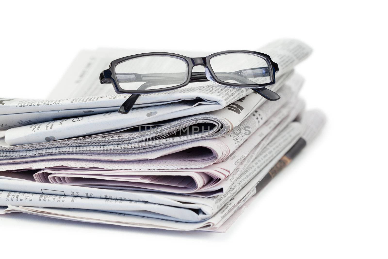 Newspapers and black glasses on a white a background