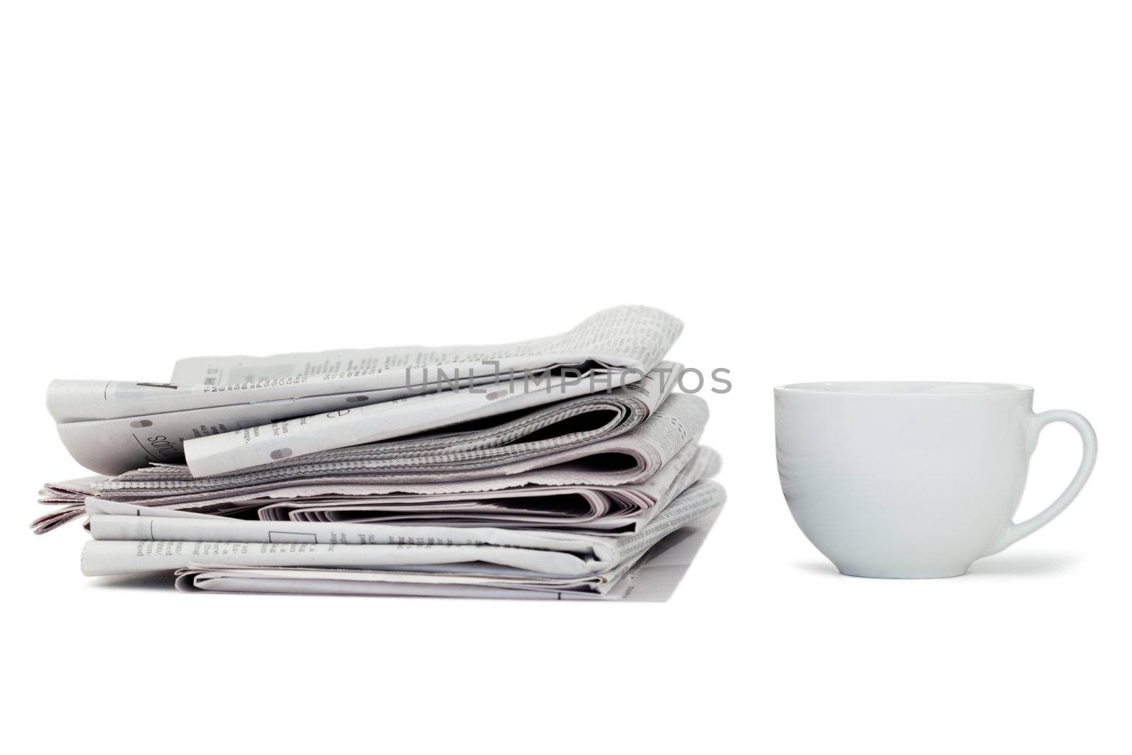 Newspapers and cup of tea on a white background