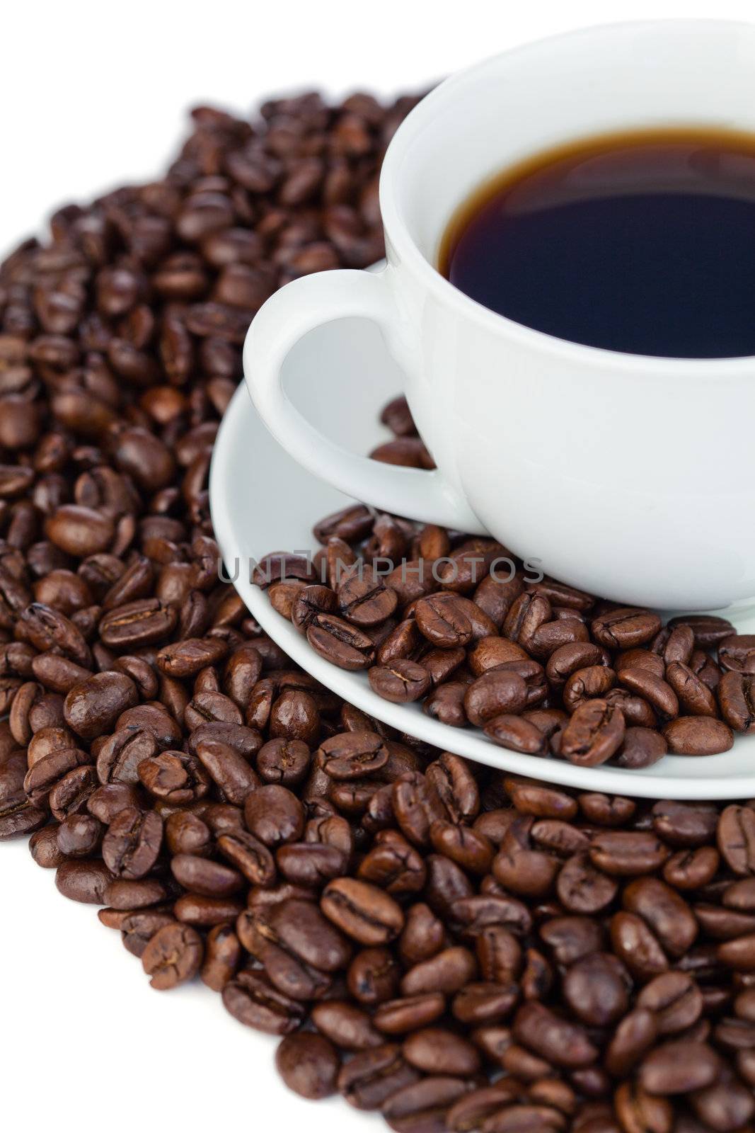 Cup of coffee and coffee beans on a white background