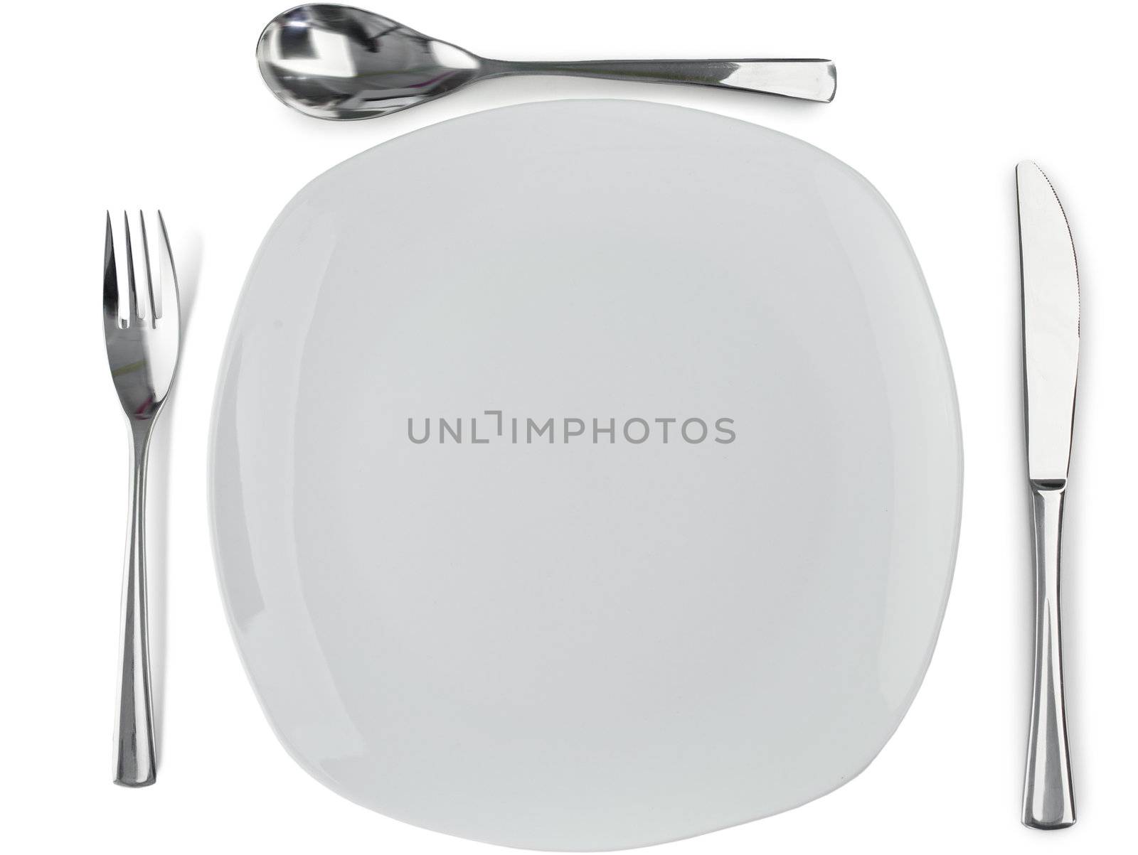 Cultery around plate on a white background