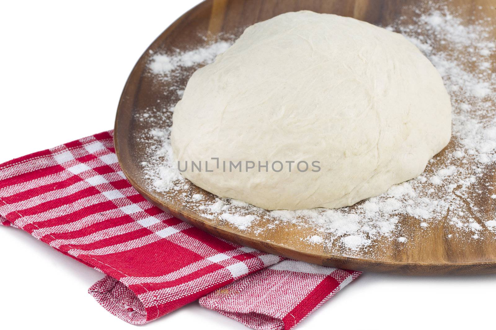 Close up image of pizza dough on wooden plate