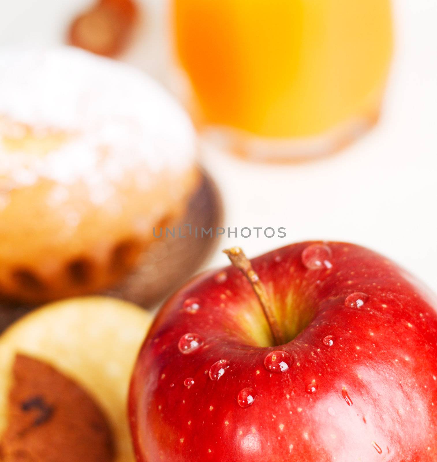 Delicious red apple with baked goods on background