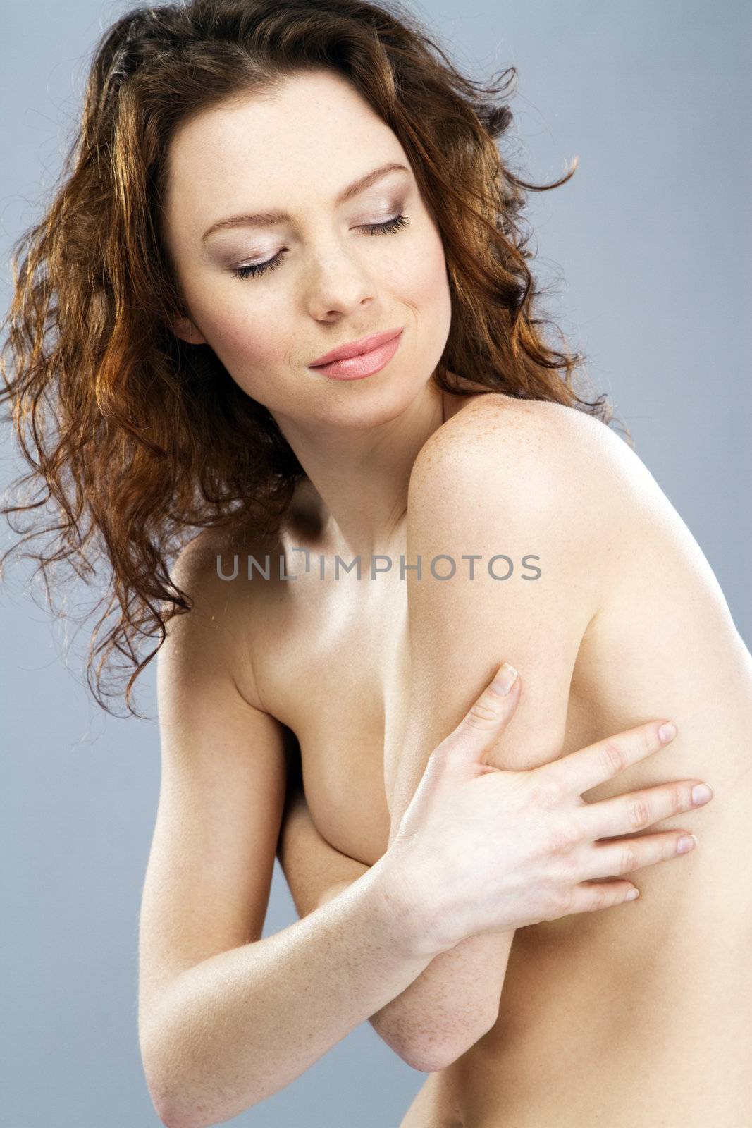 Beautiful red-haired model studio portrait by Gdolgikh