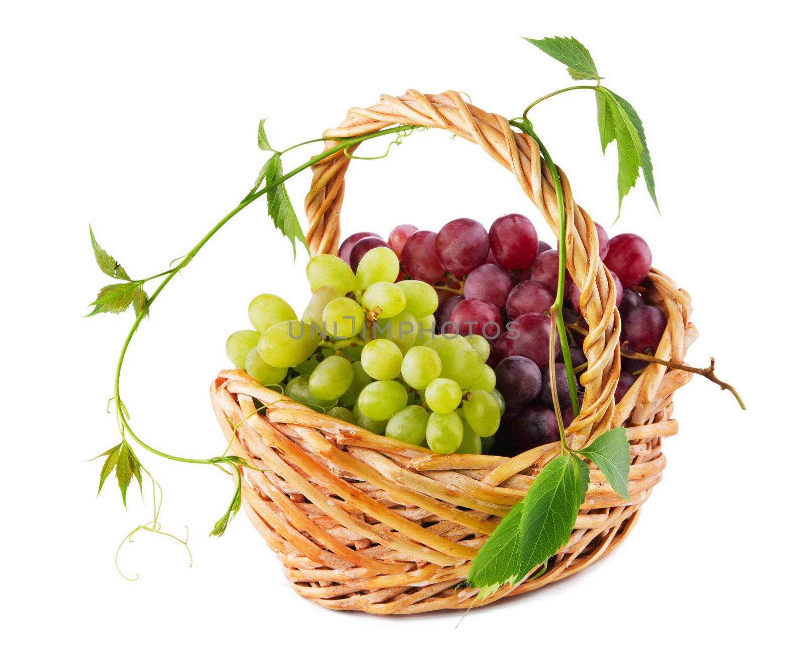 Wicker basket with grapes isolated on white background