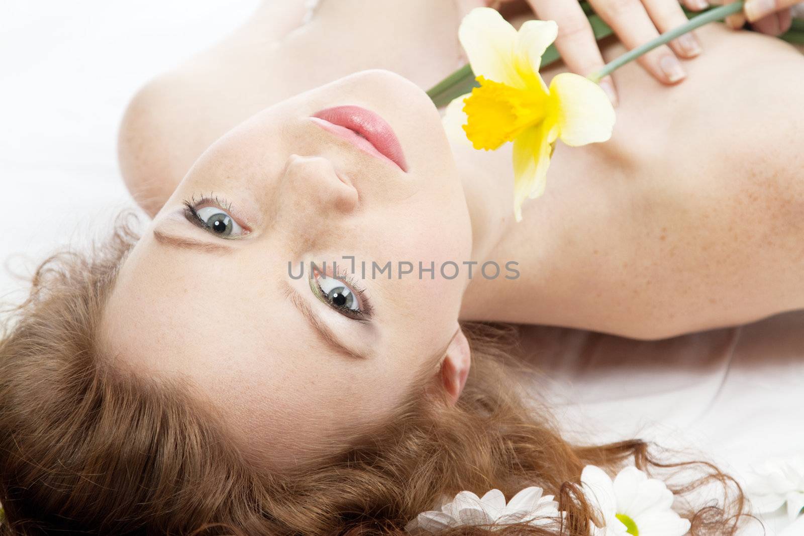 Face portrait of a beautiful model with flowers