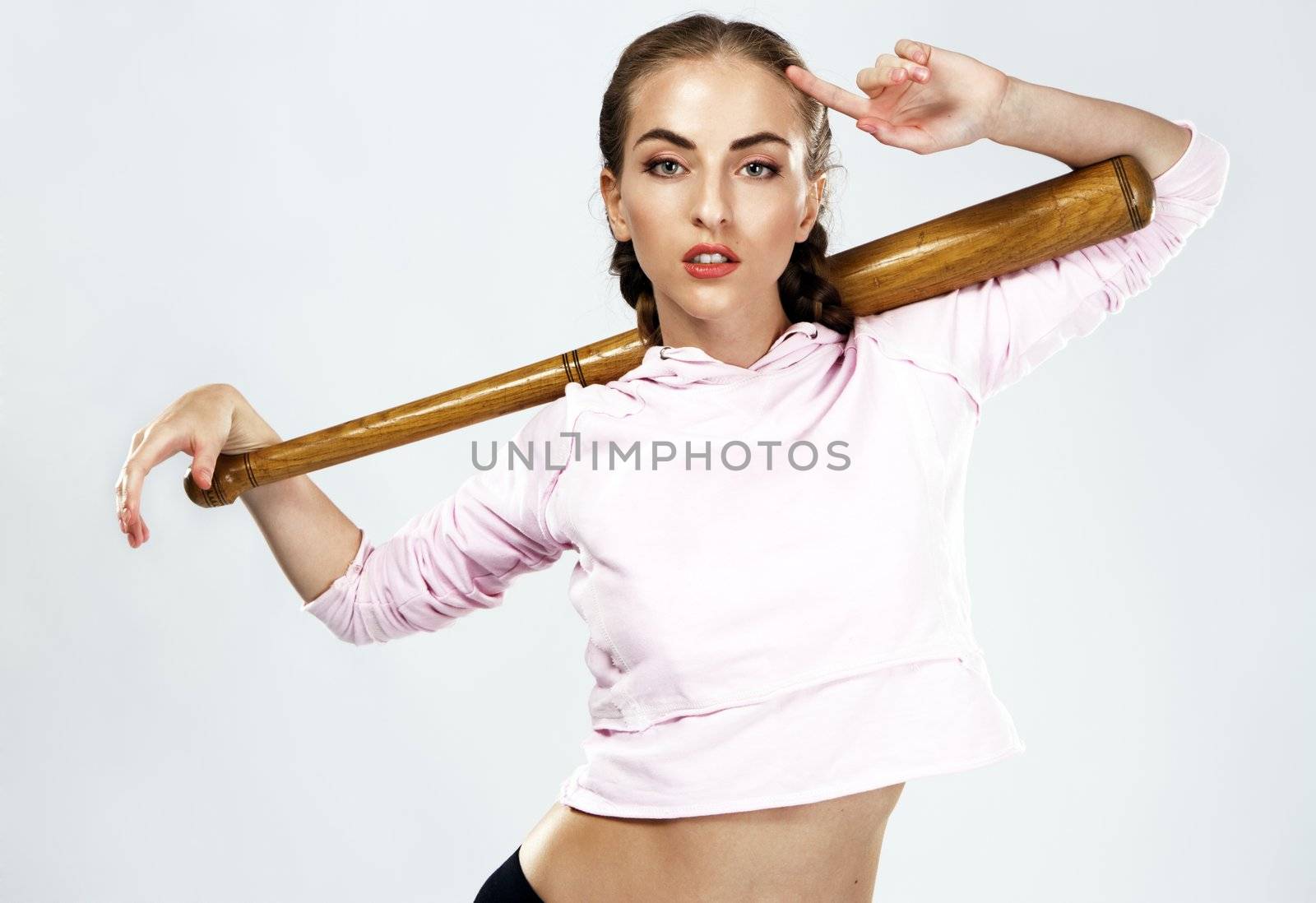 Pretty lady with a baseball bat, studio portrait