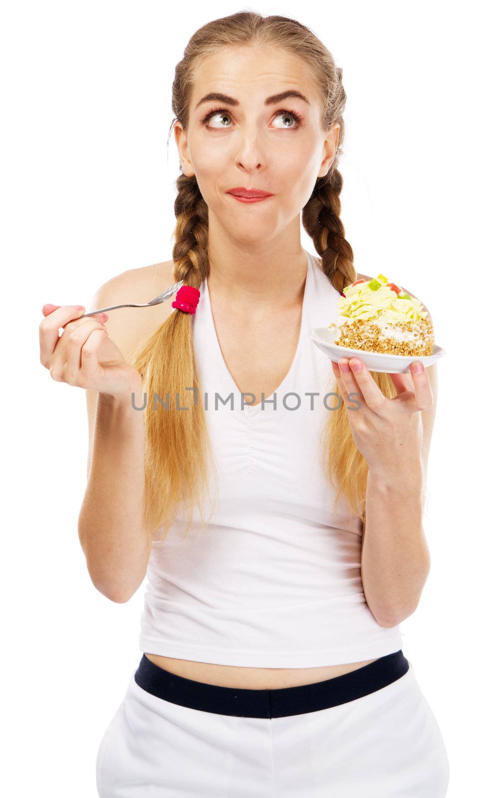 Young lady tasting a cake, studio portrait