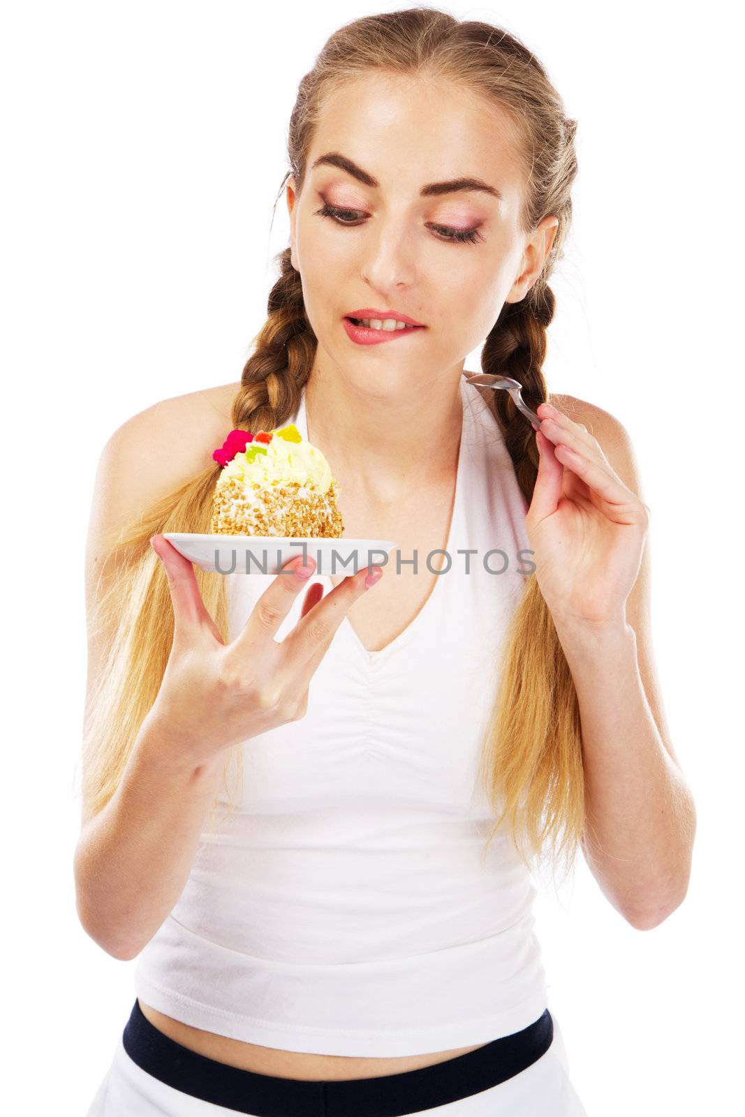 Young lady tasting a cake, studio portrait