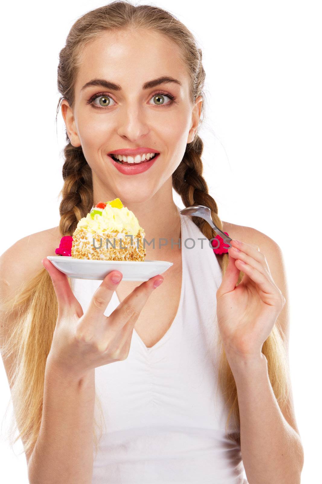 Young lady tasting a cake, studio portrait
