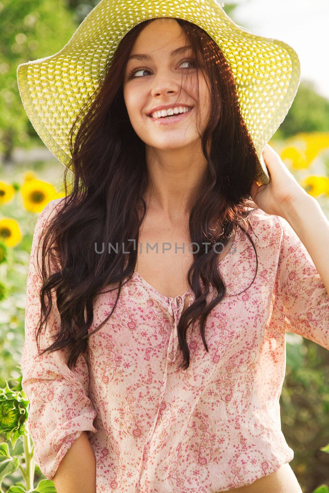 Beautiful lady walking in sunflower field