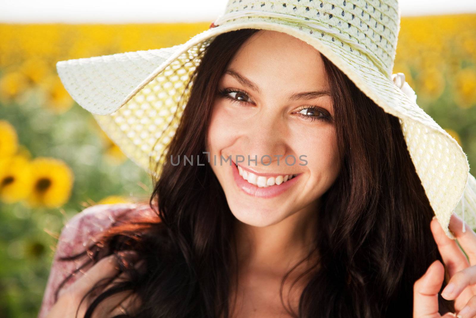 Beautiful lady walking in sunflower field