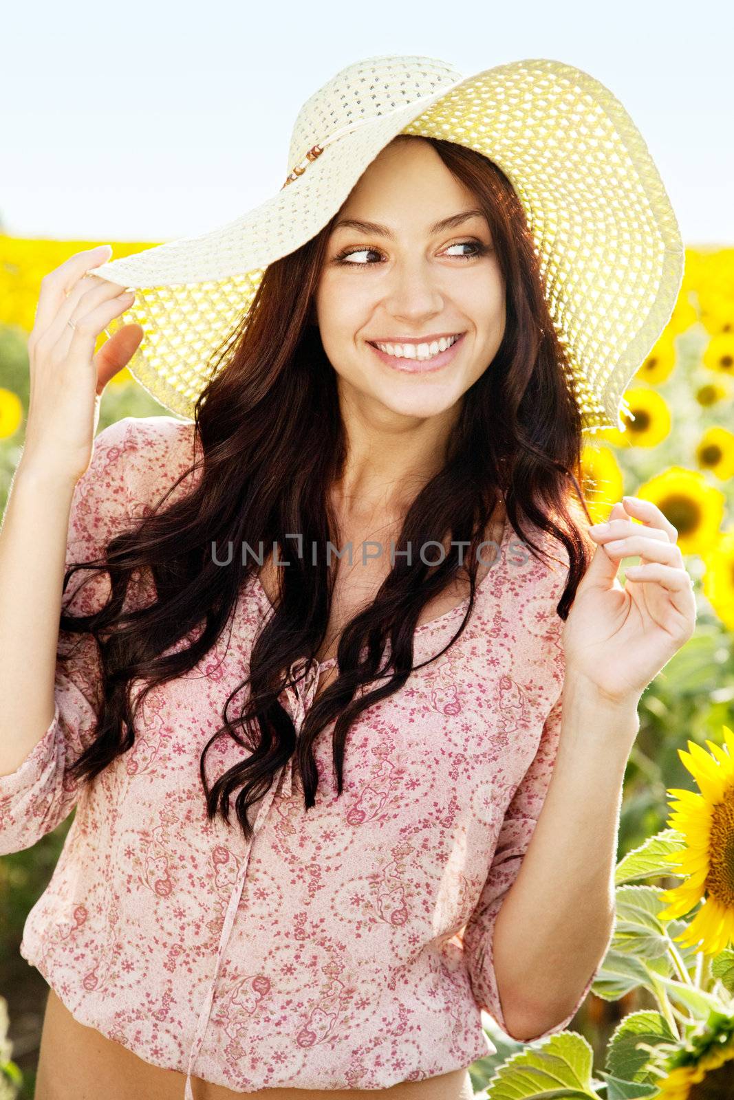 Beautiful lady walking in sunflower field