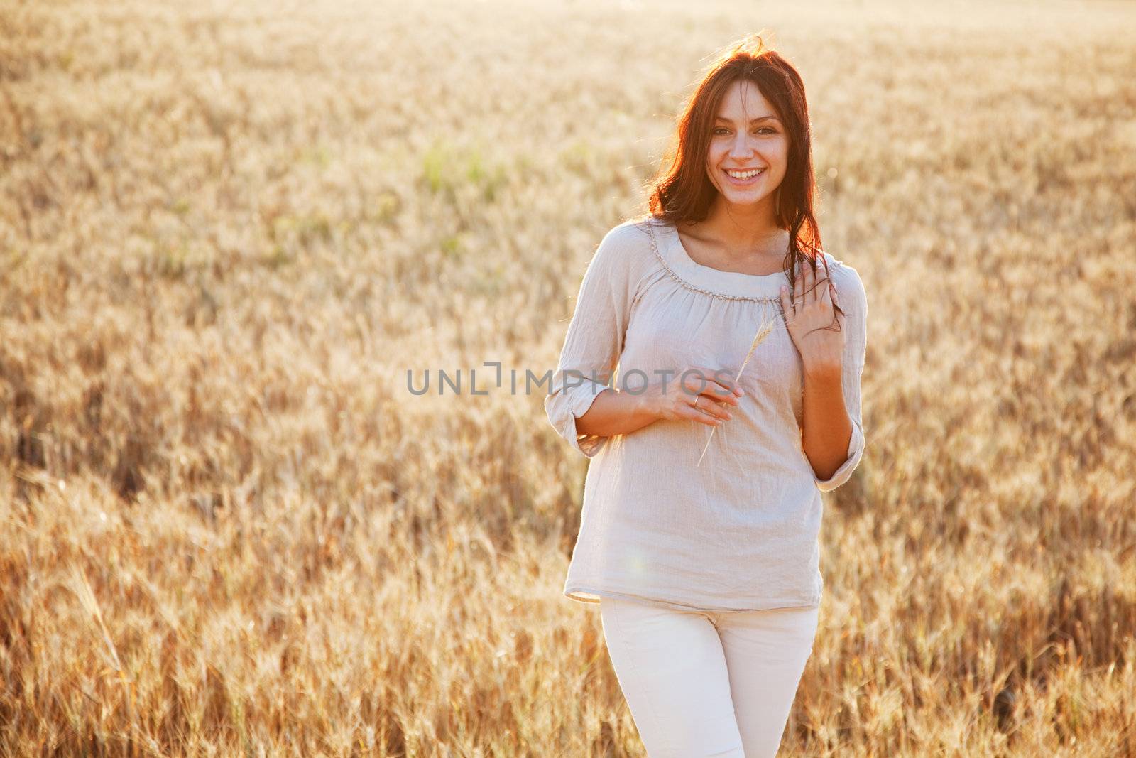 Beautiful lady in wheat field by Gdolgikh