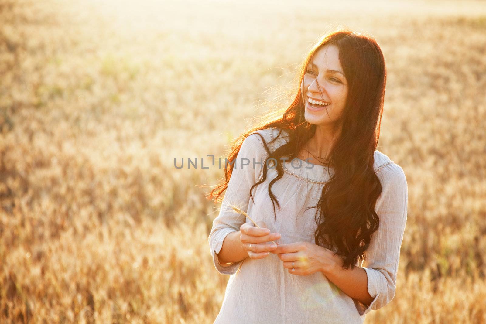 Beautiful lady in wheat field by Gdolgikh