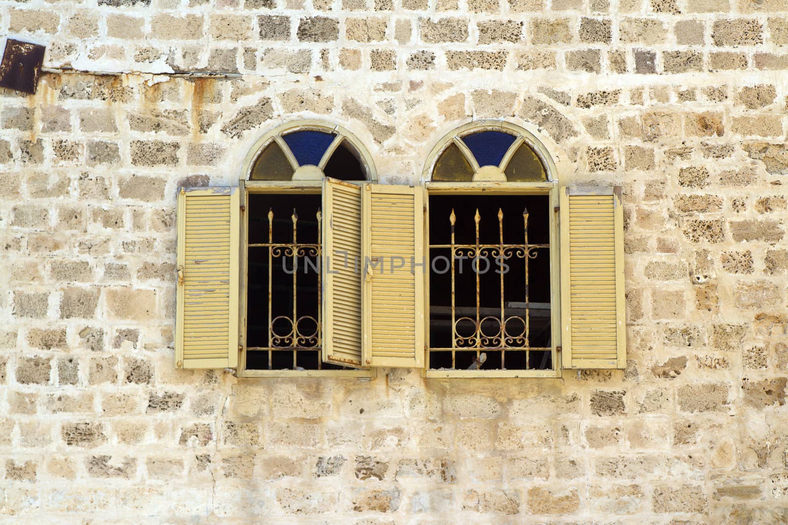 Asian stlyle windows in a yellow brick wall