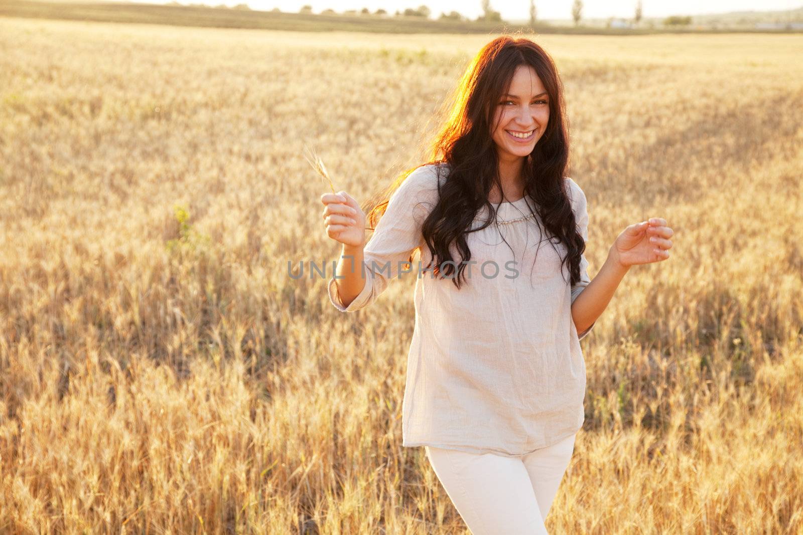 Beautiful lady in wheat field by Gdolgikh