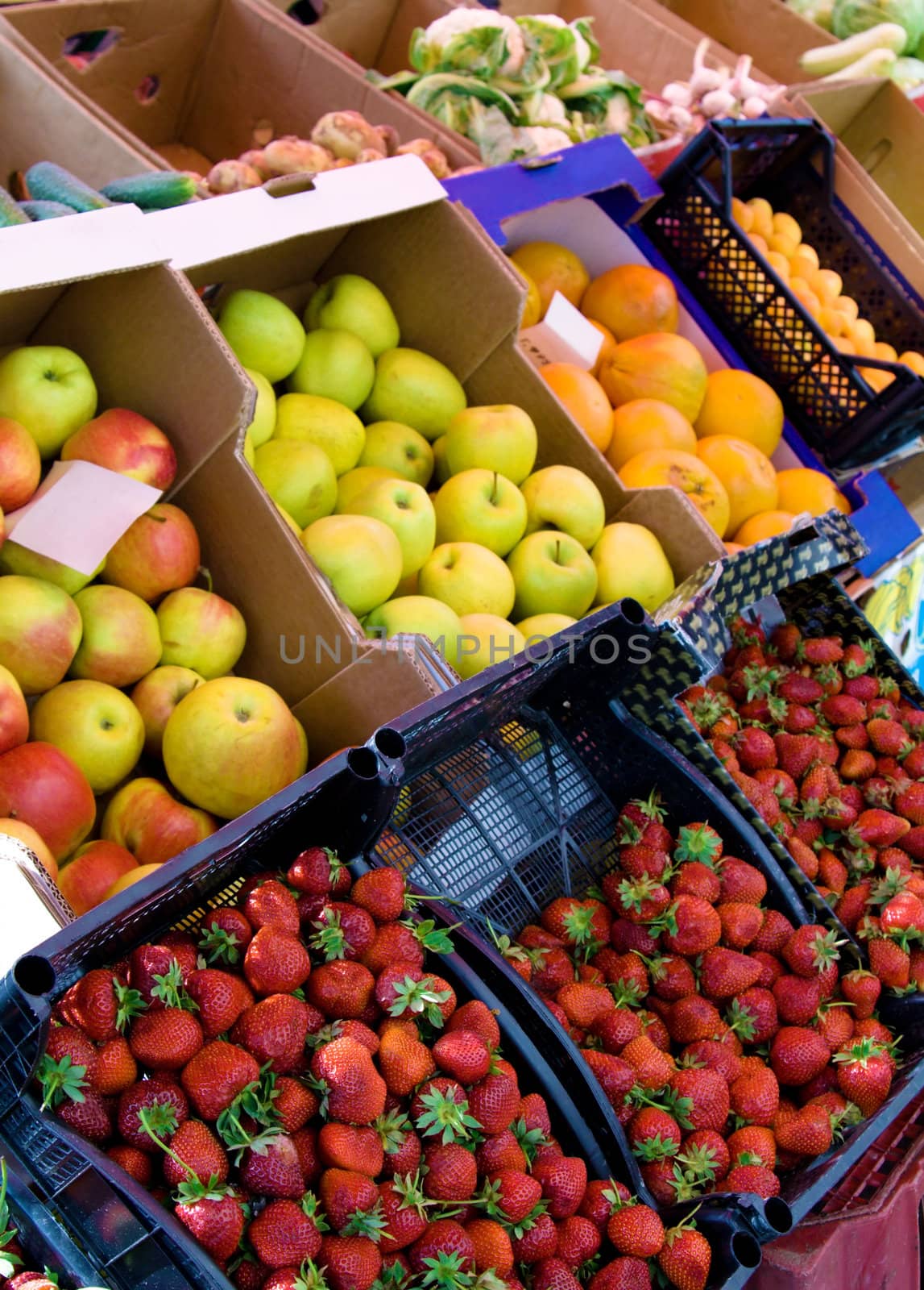 Fresh fruit and vegetables on a market by Gdolgikh