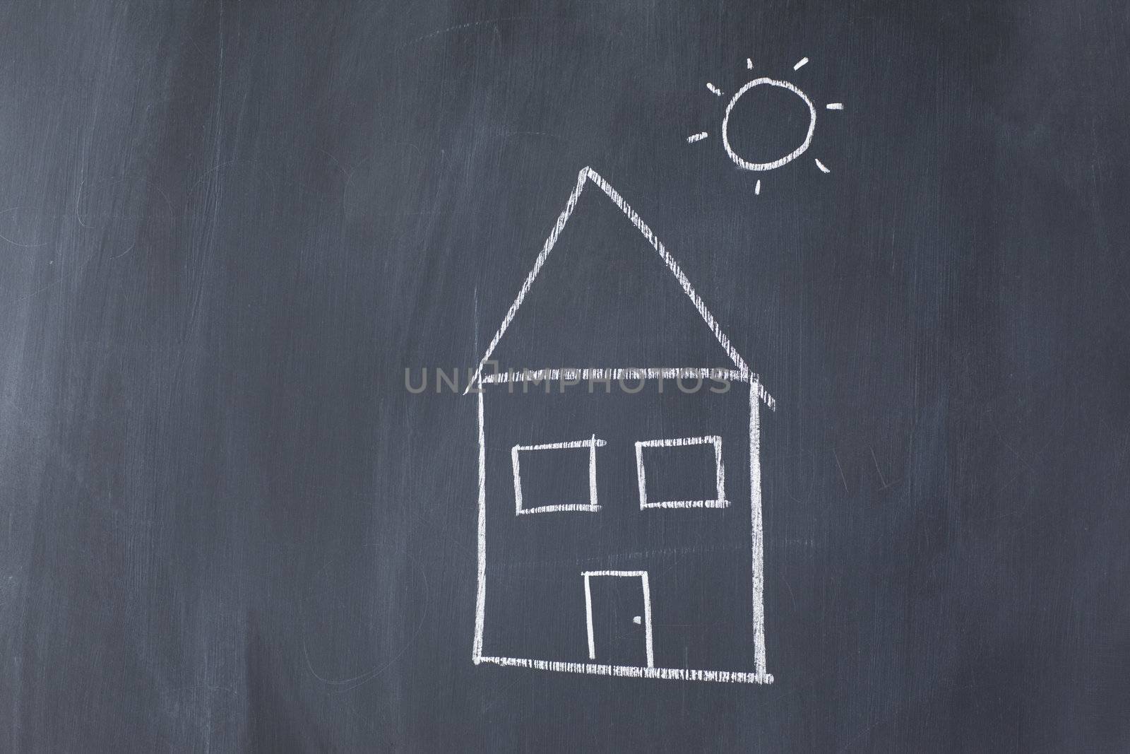 House and sun on a blackboard