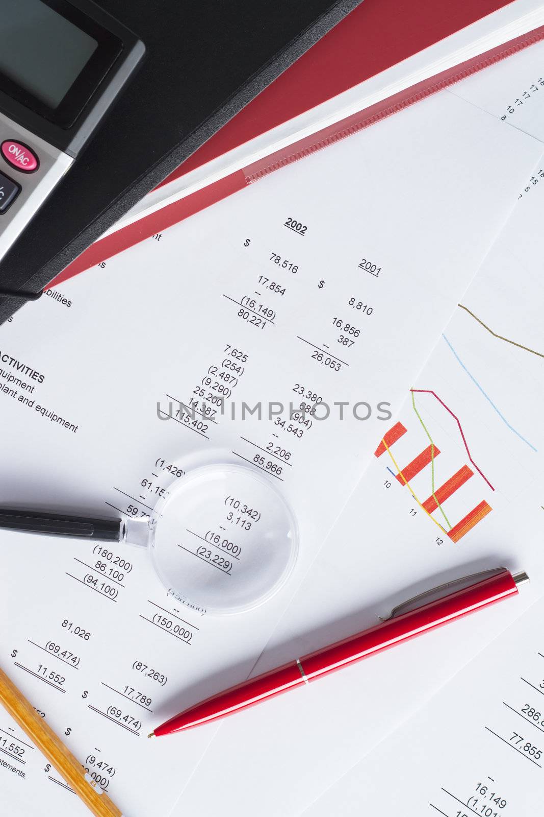 Worktable covered with financial documents by Gdolgikh