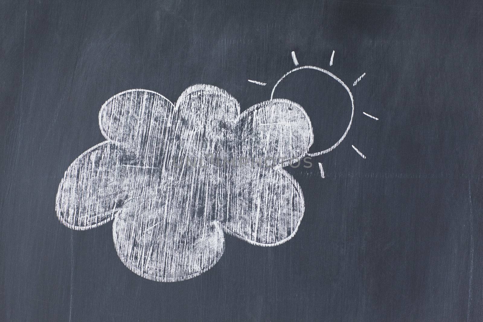 Cloud covering the sun on a blackboard