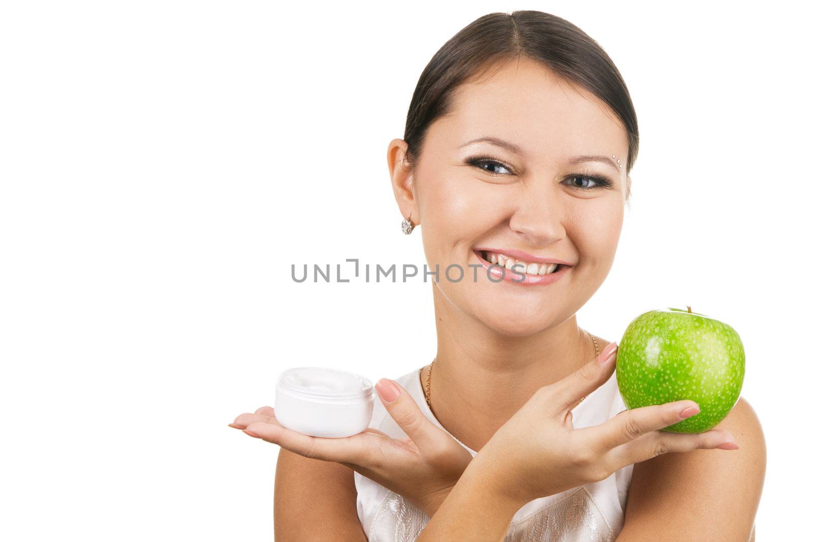 Young beautiful woman holding an apple and skin cream by Gdolgikh