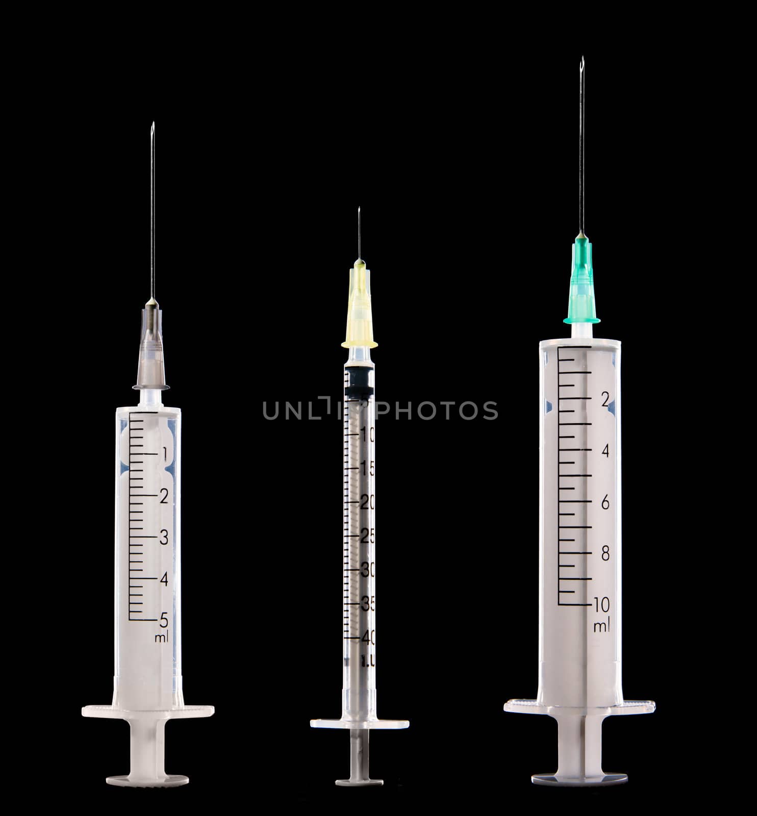 Three syringes on black background