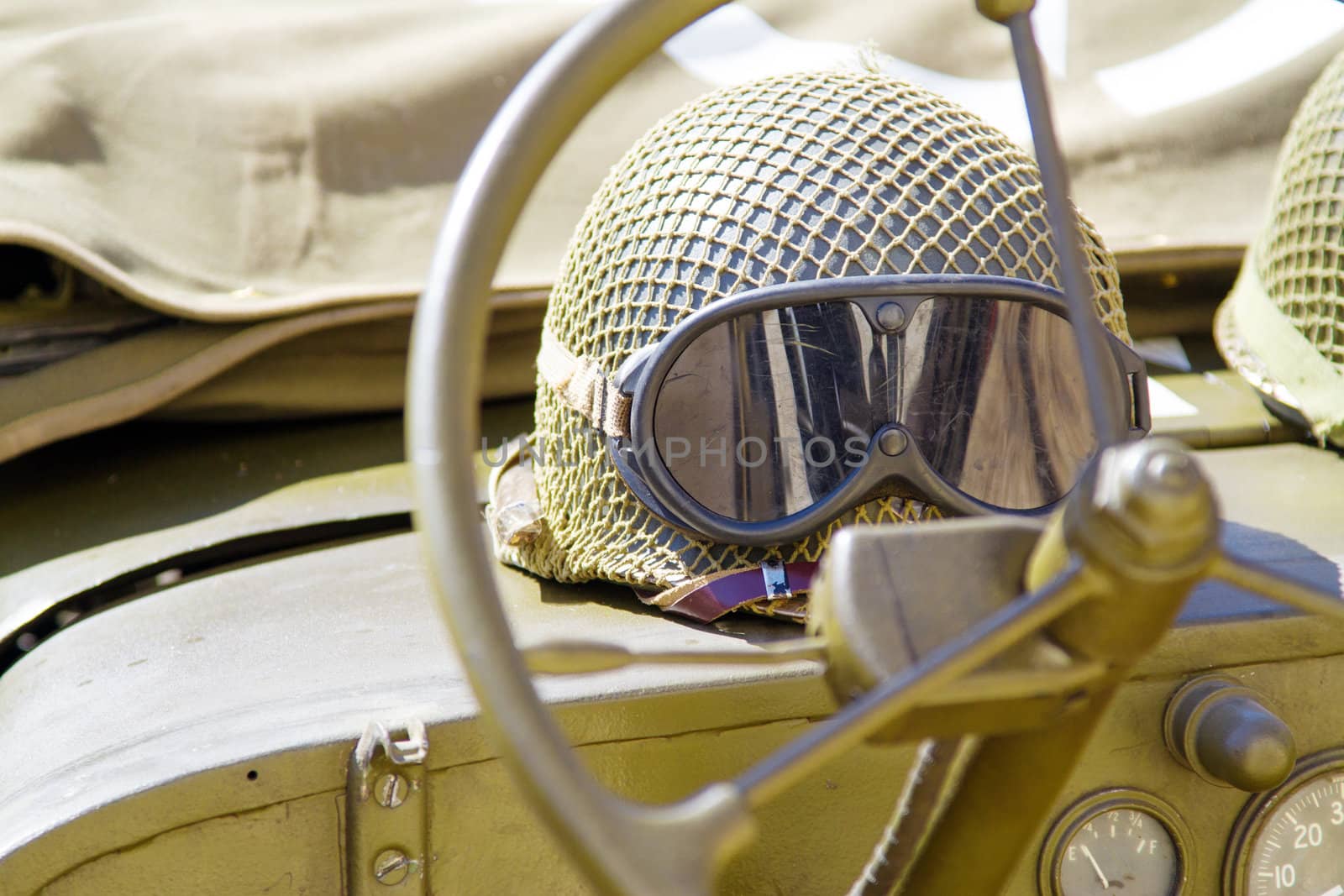 Military helmet lying on a off-road car