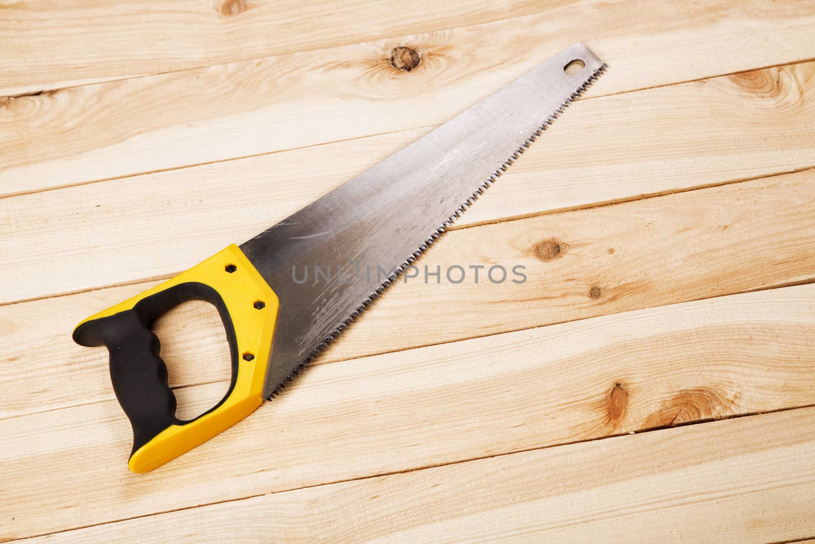 Wood saw on pine desks closeup photo