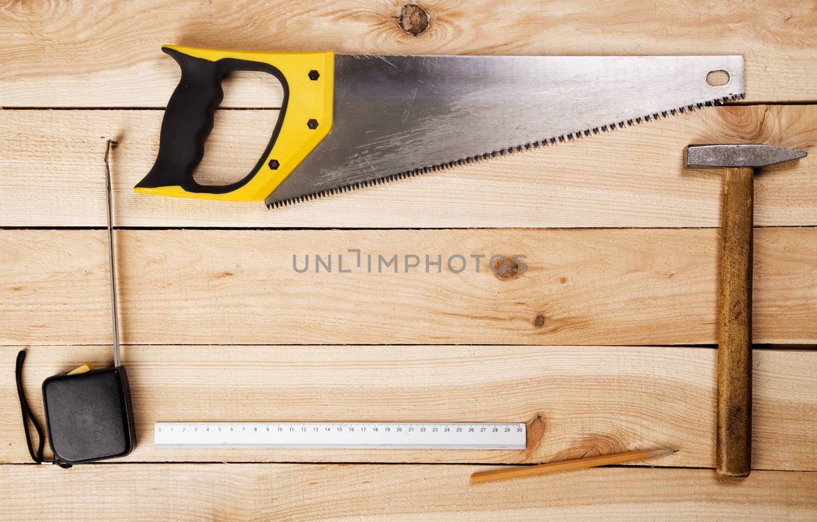 Carpenter's tools on pine desks, closeup photo