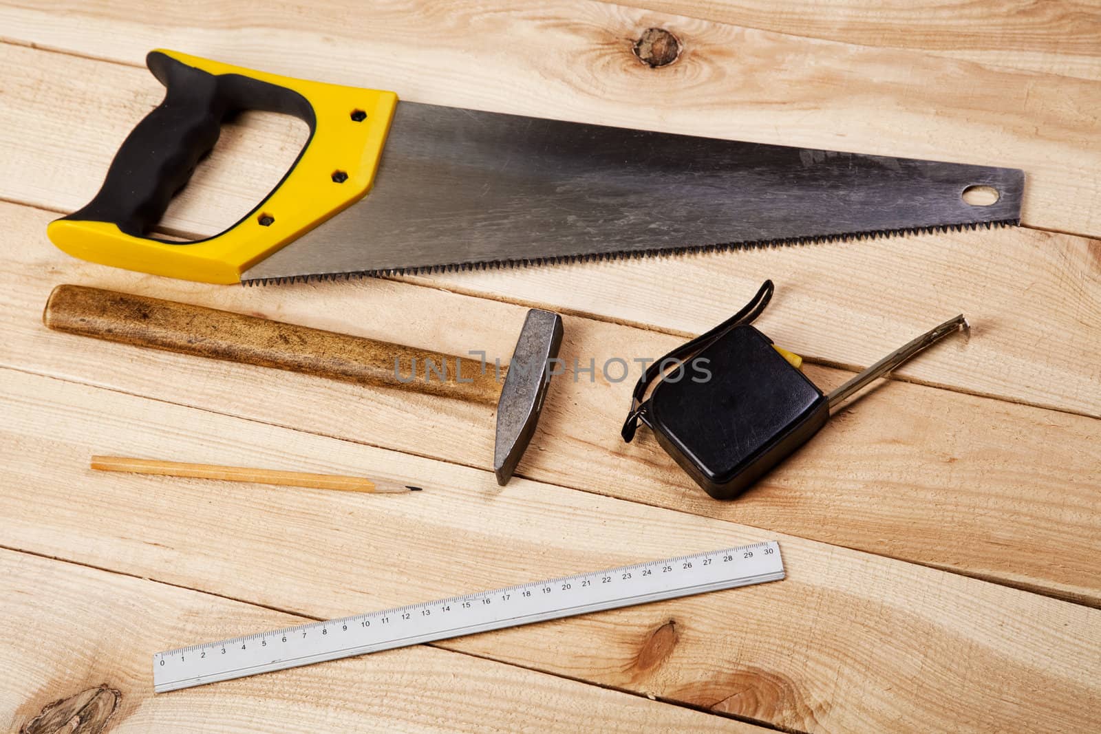 Carpenter's tools on pine desks, closeup photo