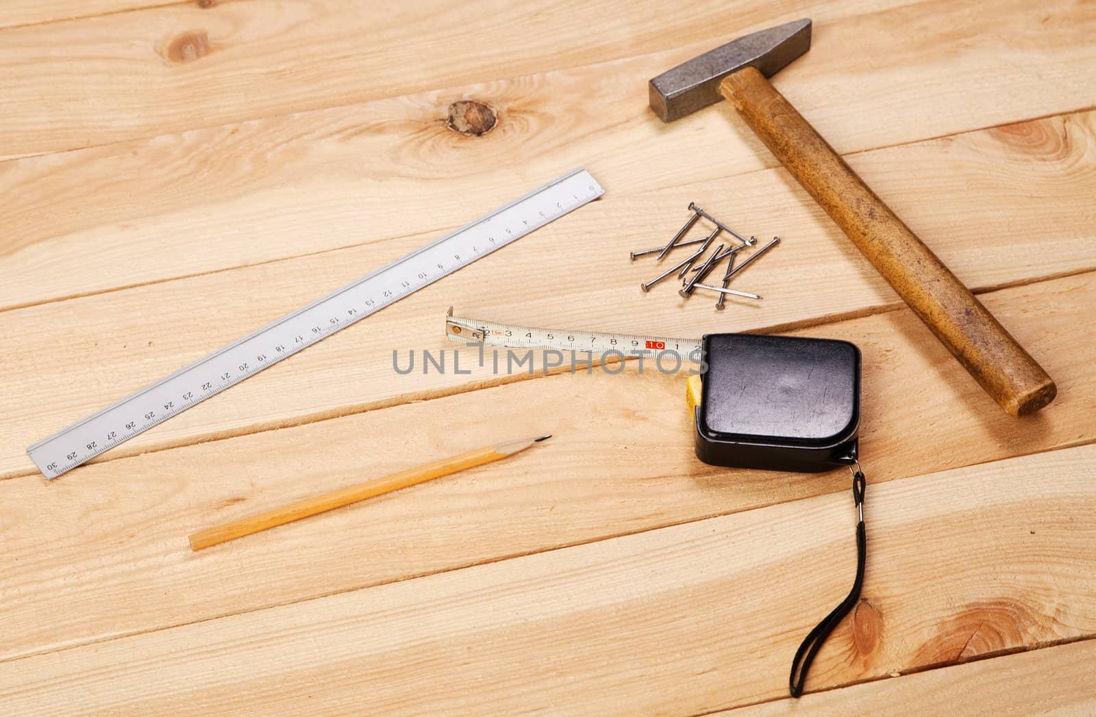 Carpenter's tools on pine desks, closeup photo