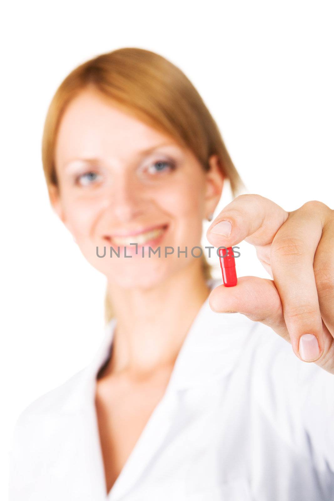 Young attractive doctor holding a pill by Gdolgikh