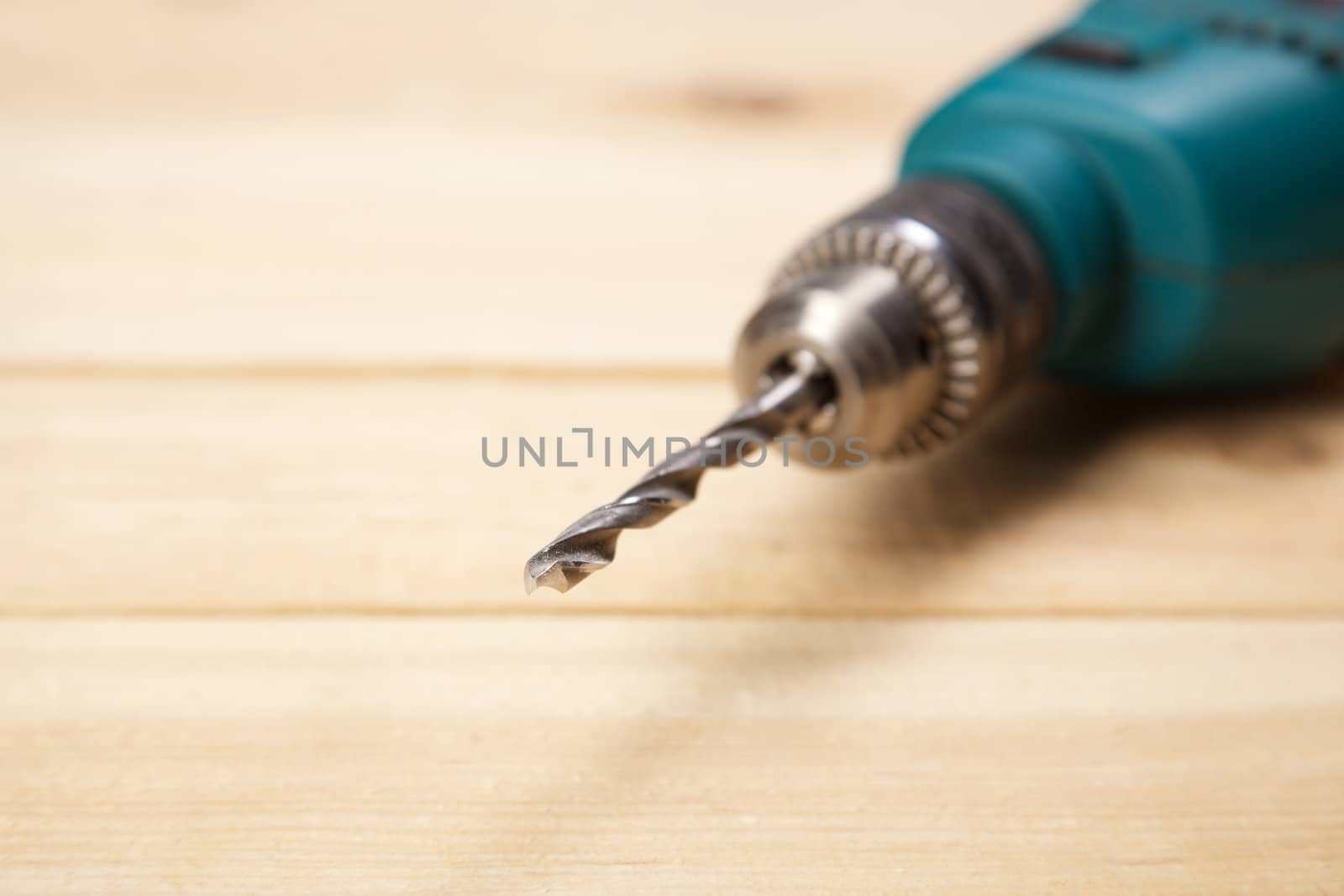 Drill on pine desks closeup photo