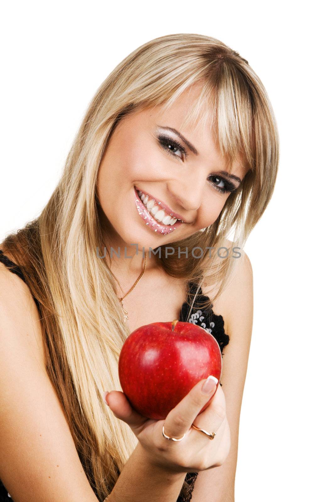 Cheerful young woman holding a fresh green apple, with crystals on her lips